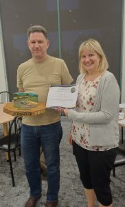 Helen receiving 2025 Club person of the year award from President Ken 